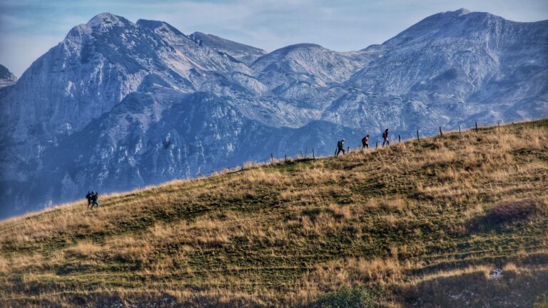 Beginner hiker walking on a mountain trail.