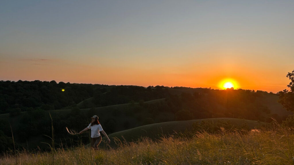 girl in the hills with sunset